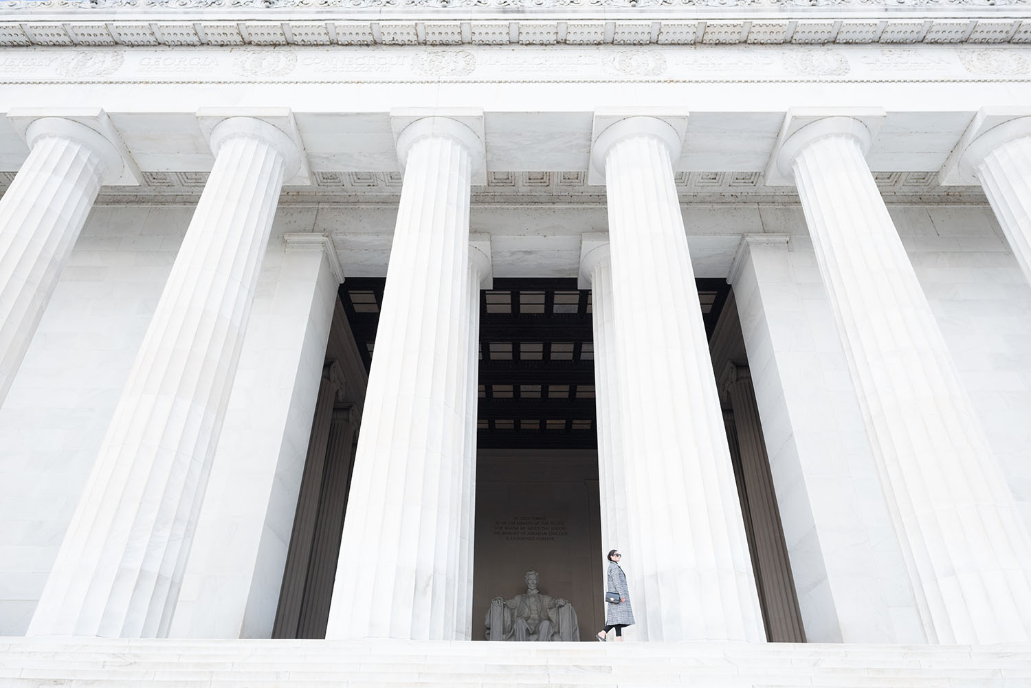 Winnipeg fashion blogger Cee Fardoe of COoc & Vera walks along the Lincoln Memorial wearing a Sheinside coat and Paige jeans